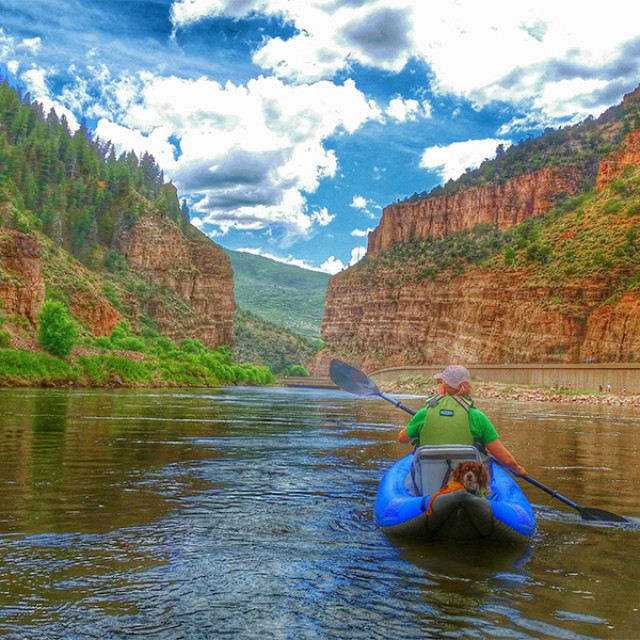 Kayaker paddling along the Colorado River through Glenwood Canyon in Colorado